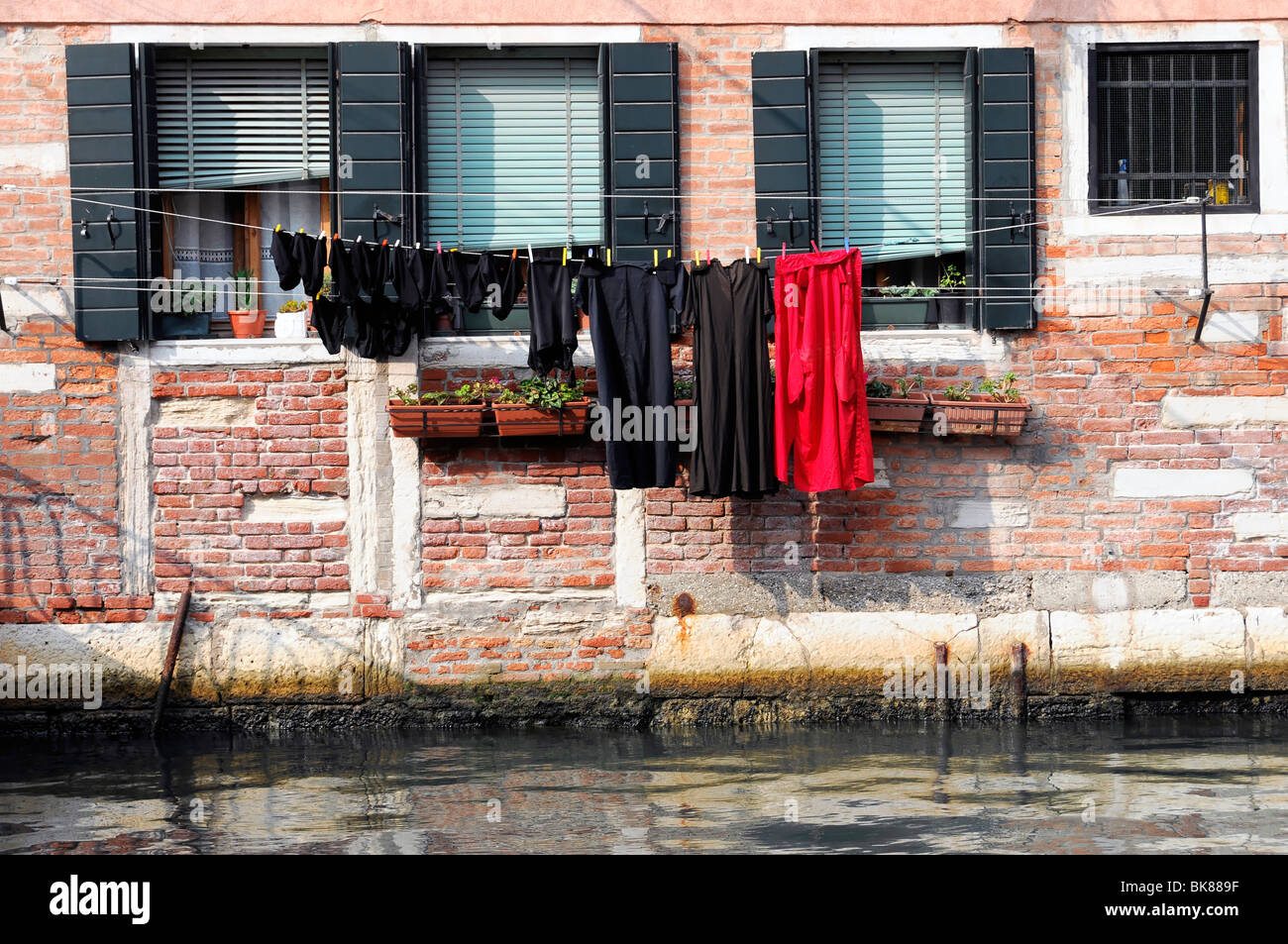 Washing hanging on a clothesline, canal in front of a house, Venice, Veneto, Italy, Europe Stock Photo