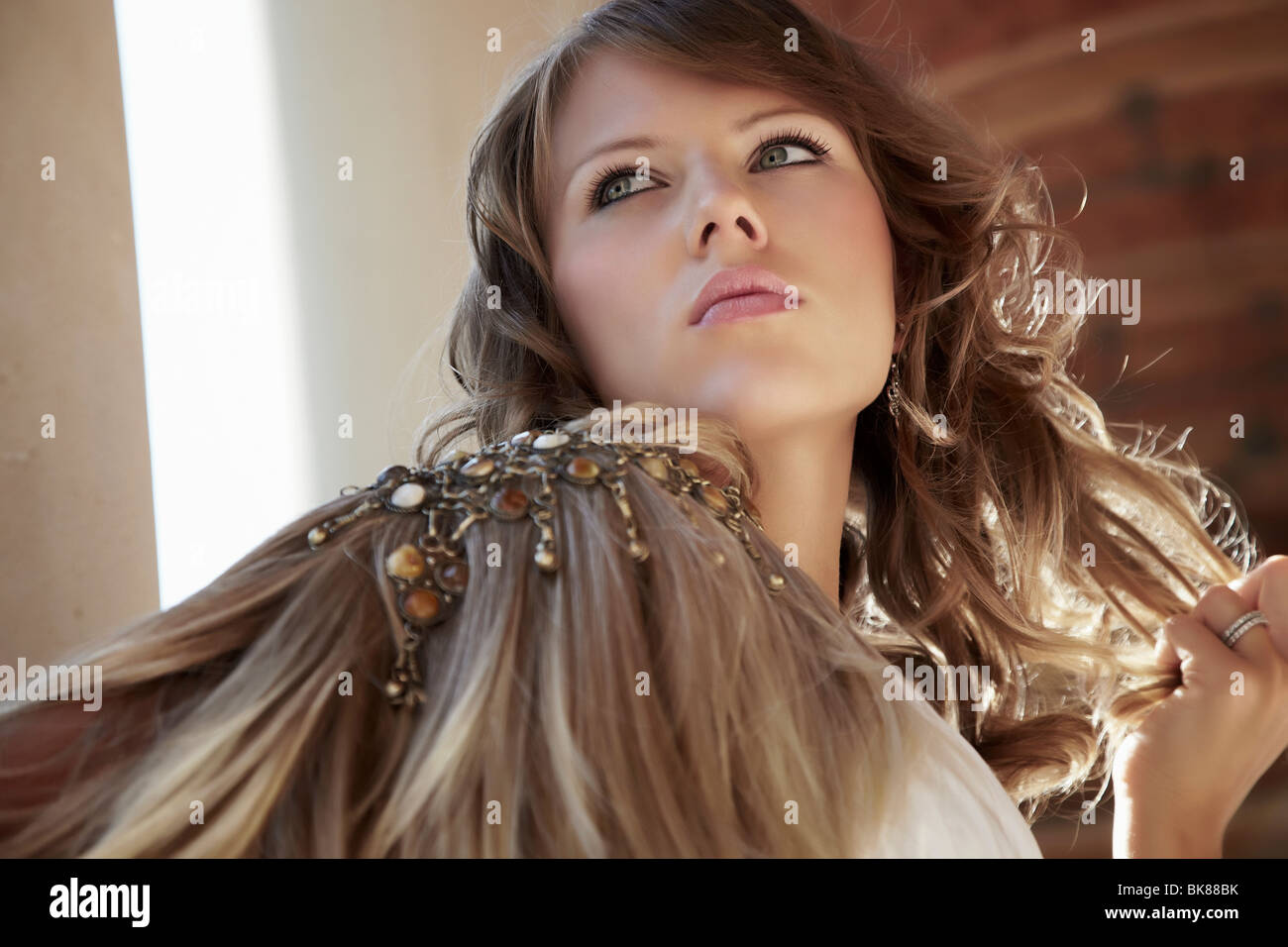 Portrait of a young woman wearing shoulder jewelry and beads Stock Photo