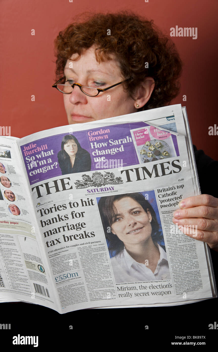 Woman at home reading The Times newspaper Stock Photo