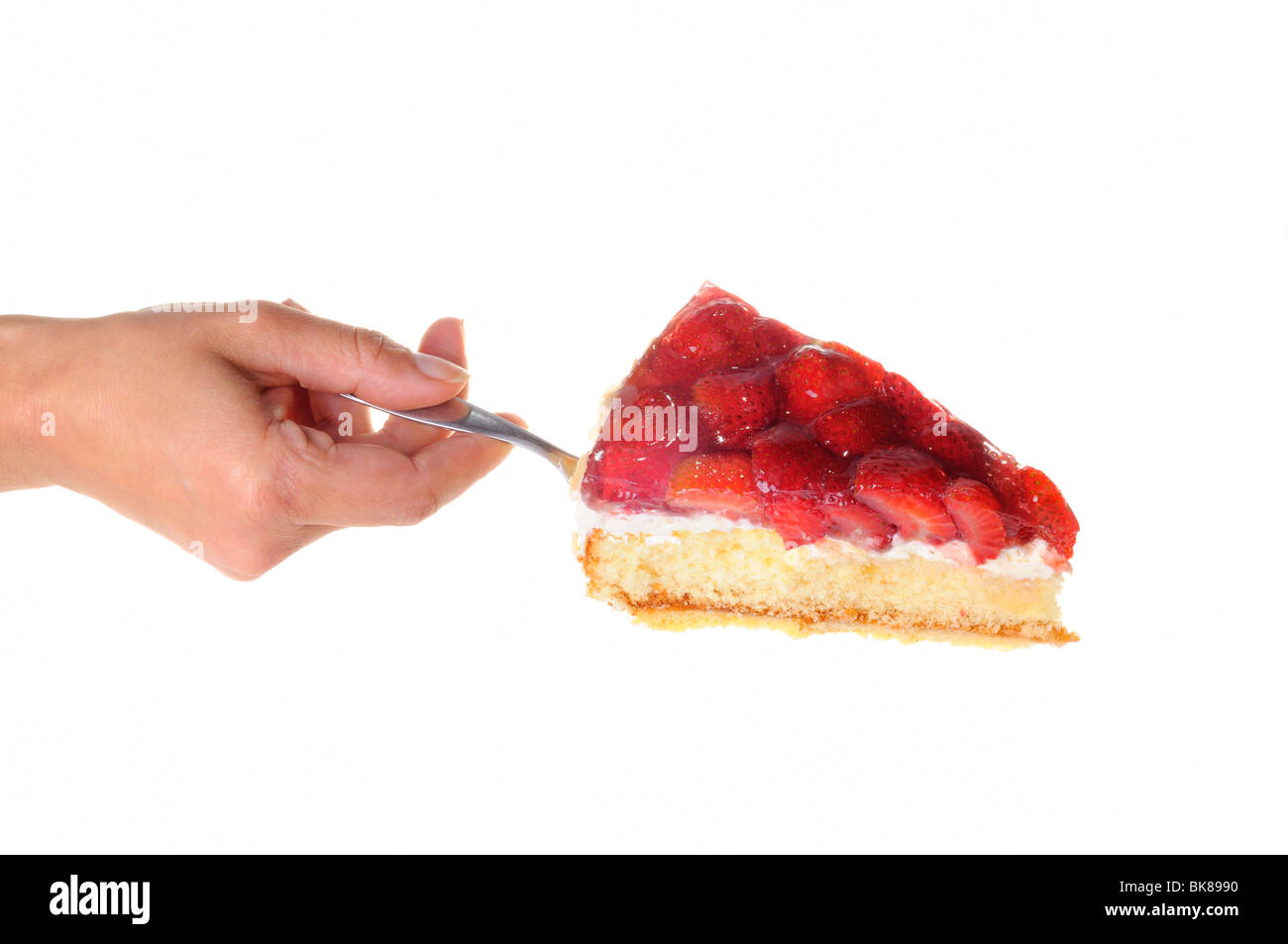 Woman's hand serving a piece of strawberry cake on a cake server Stock Photo