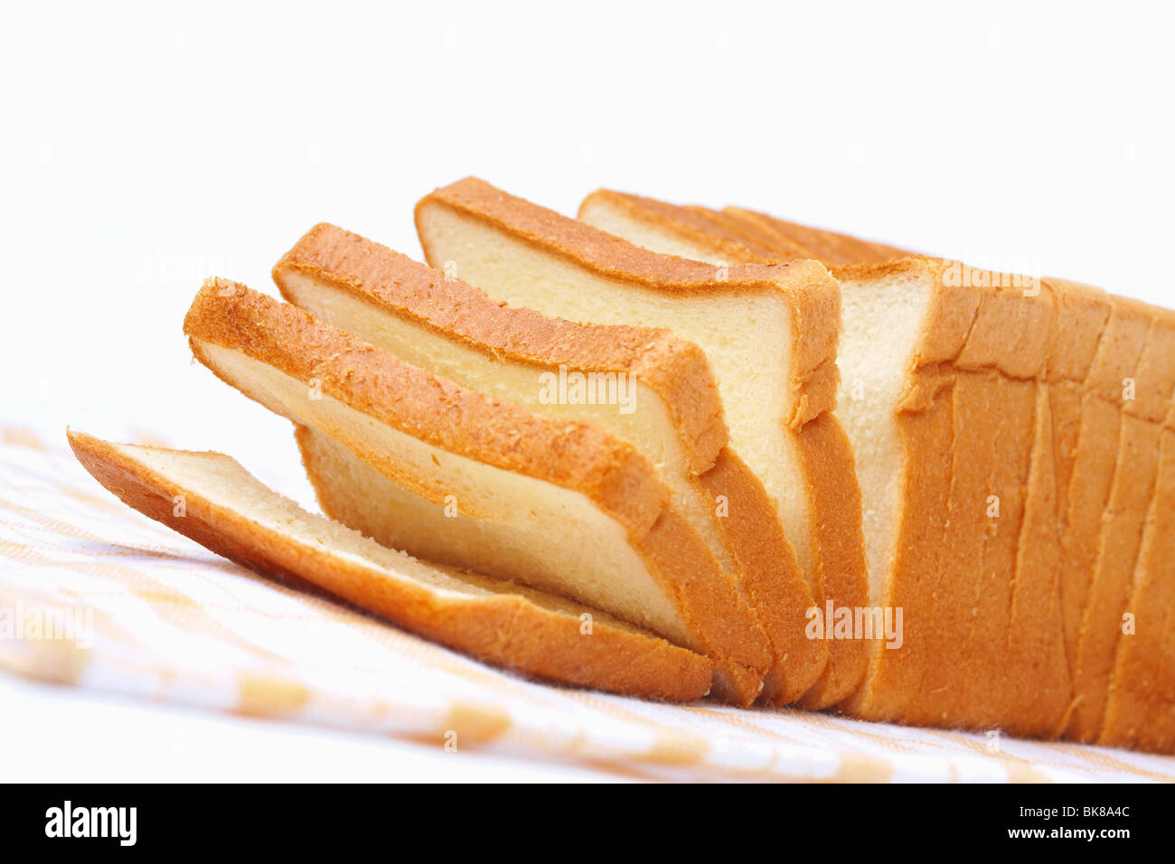 Sliced white bread for toasts on white background Stock Photo - Alamy