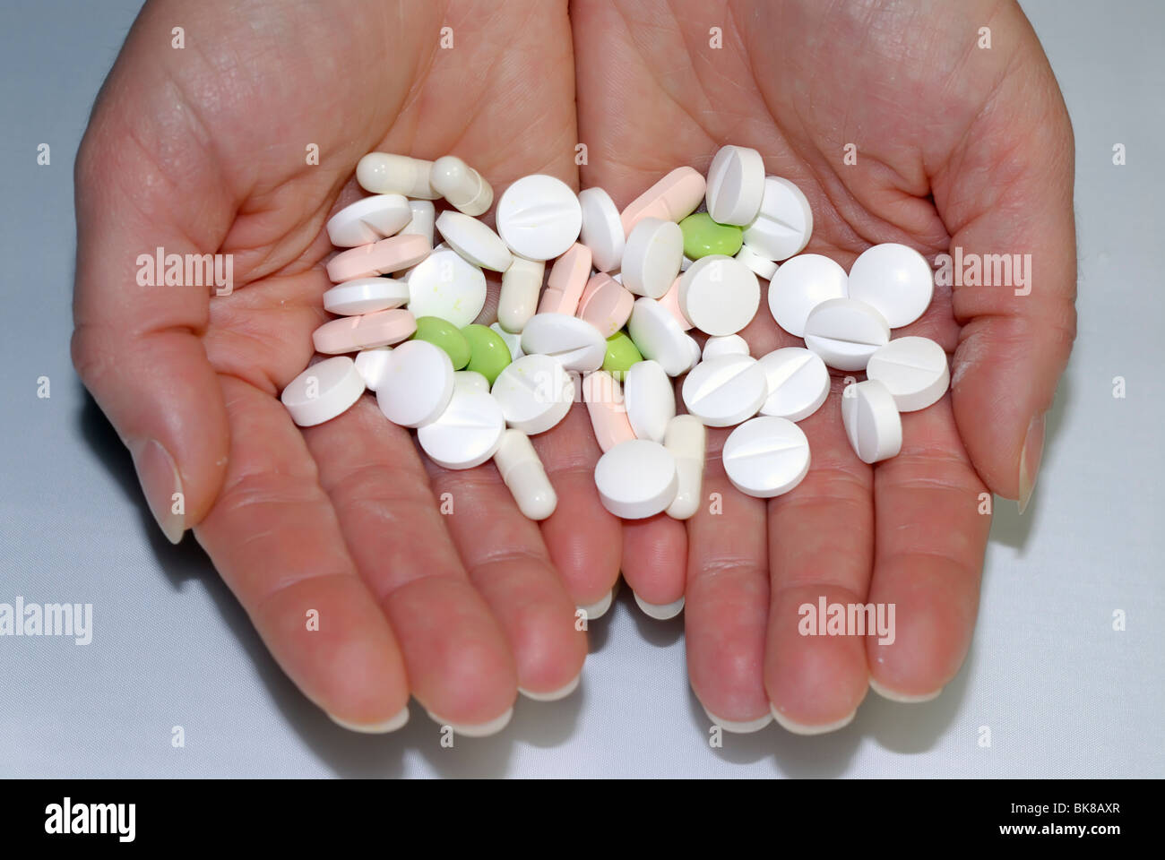 Tablets and pills on hands Stock Photo