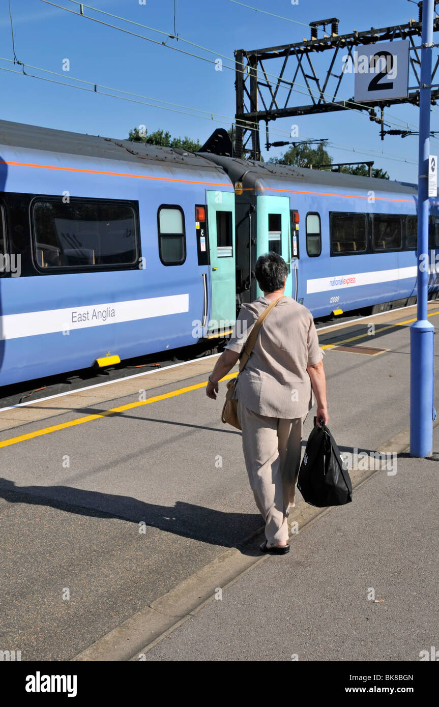 Woman 68 years about to board train Stock Photo