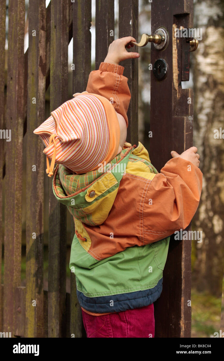 Little girl at a garden gate Stock Photo