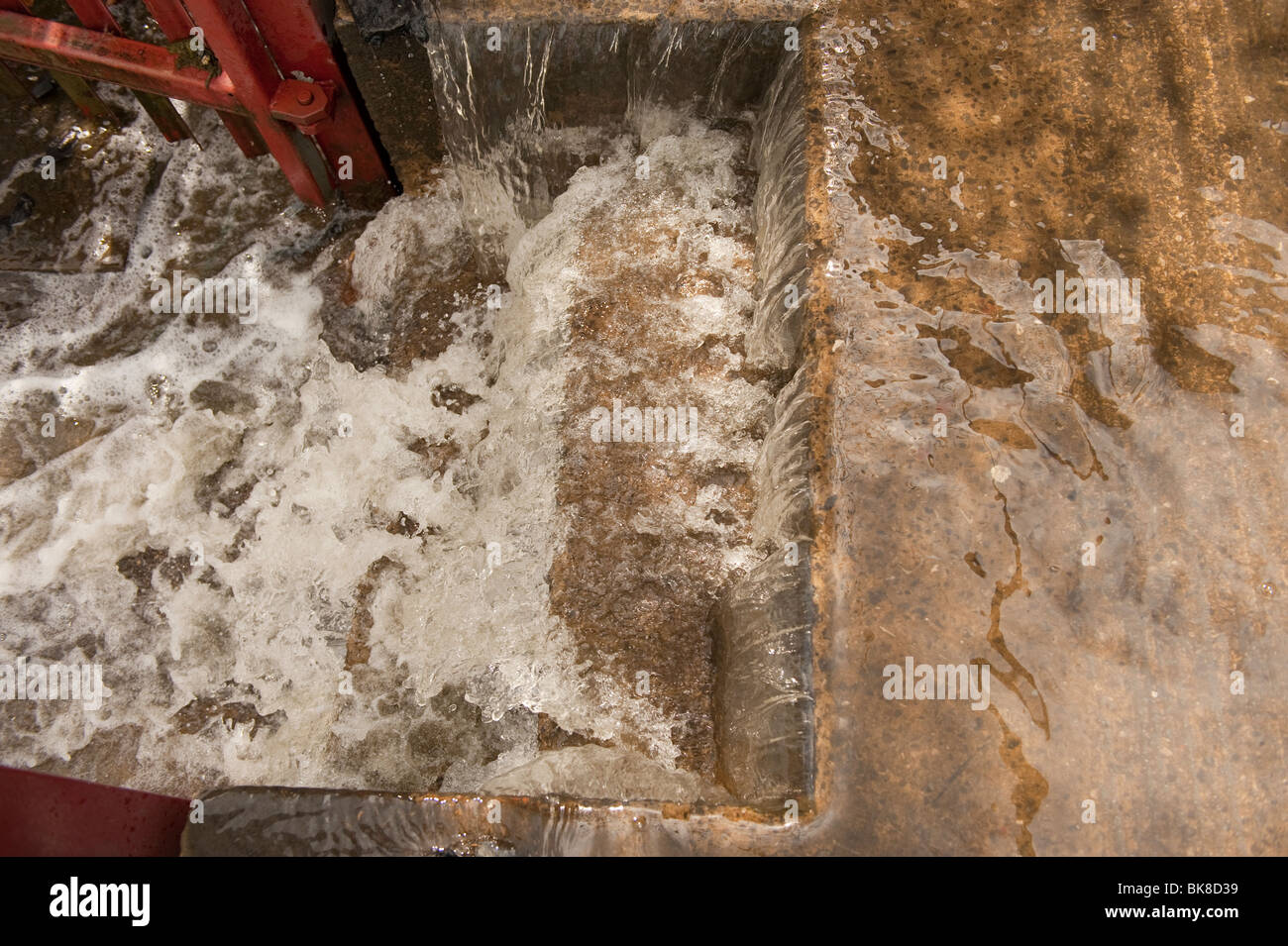 Flood water pouring down concrete steps Stock Photo