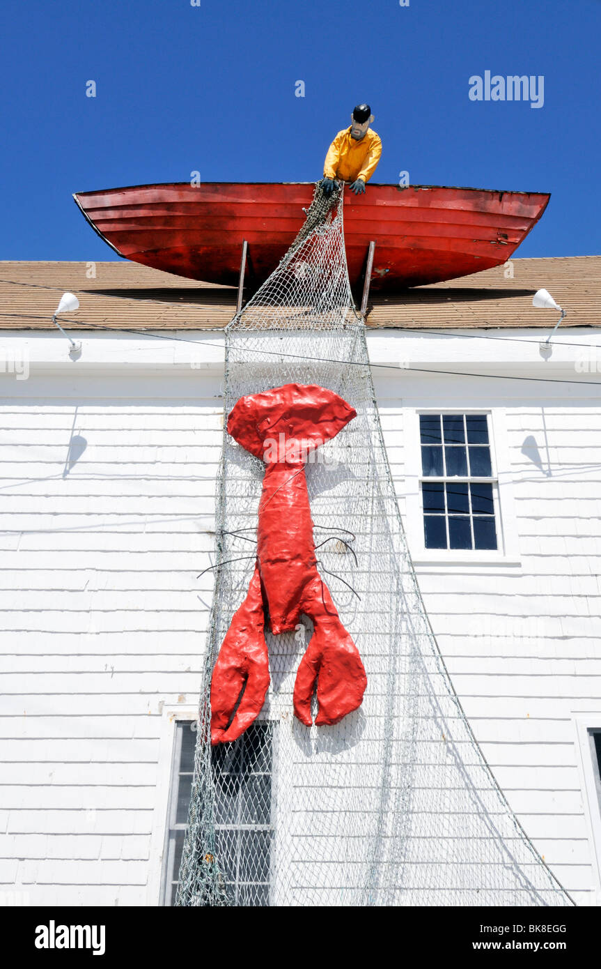 Lobstermen in boat with netting over side and lobster in netting on roof of Macs Seafood restaurant in Wellfleet, Cape Cod USA Stock Photo