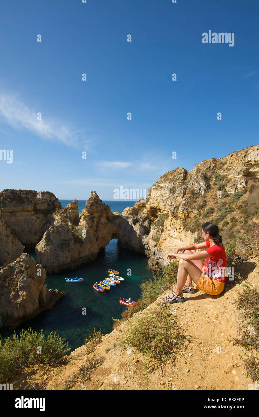 Woman overlooking Ponta da Piedade near Lagos, Algarve, Portugal, Europe Stock Photo