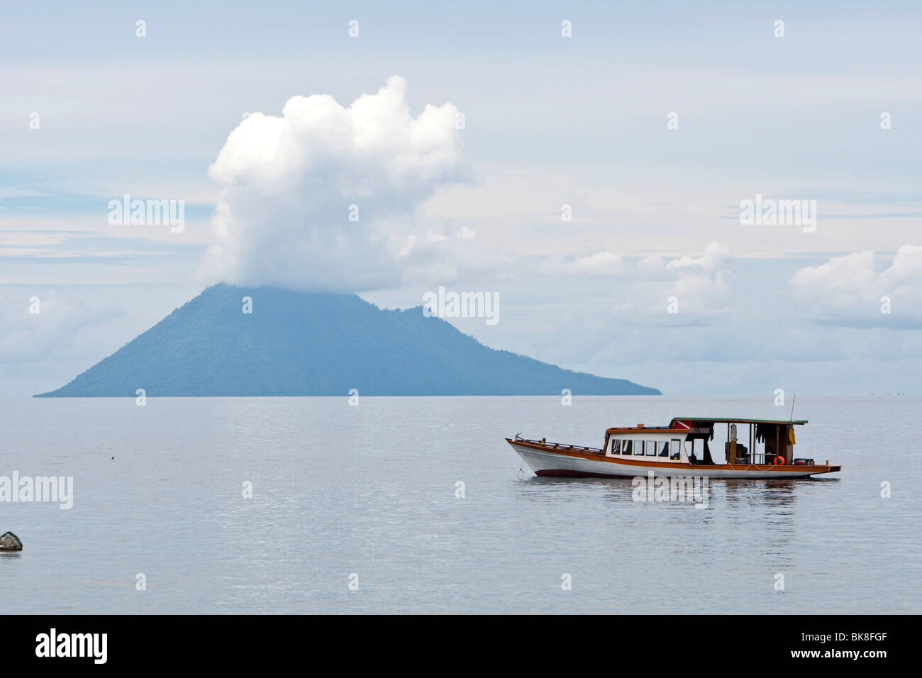 Diving boat in the Bunaken Marine Park in front of Mt Manado Tua, North Sulawesi, Indonesia Stock Photo