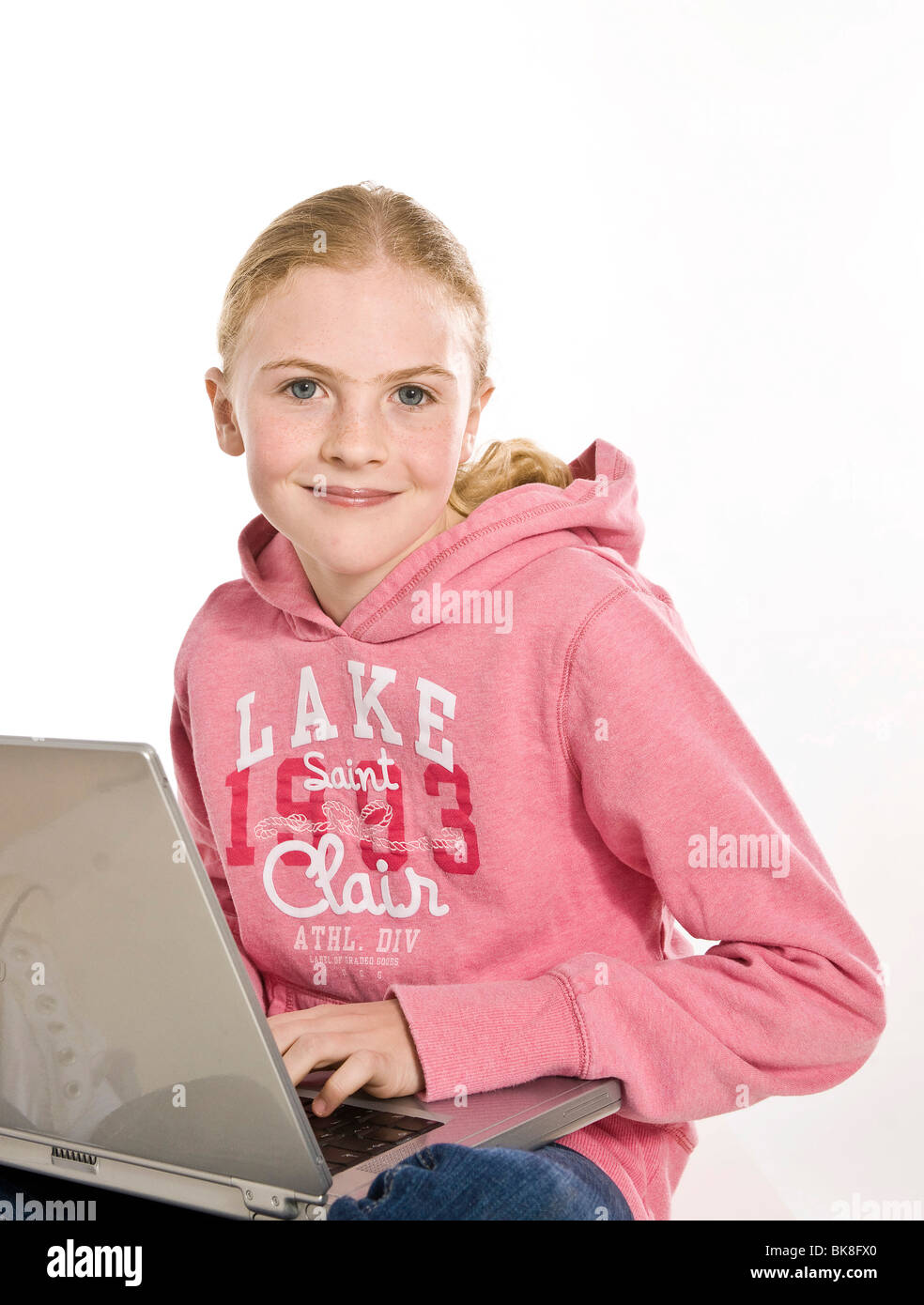 Portrait of a smiling blonde girl with a laptop Stock Photo - Alamy