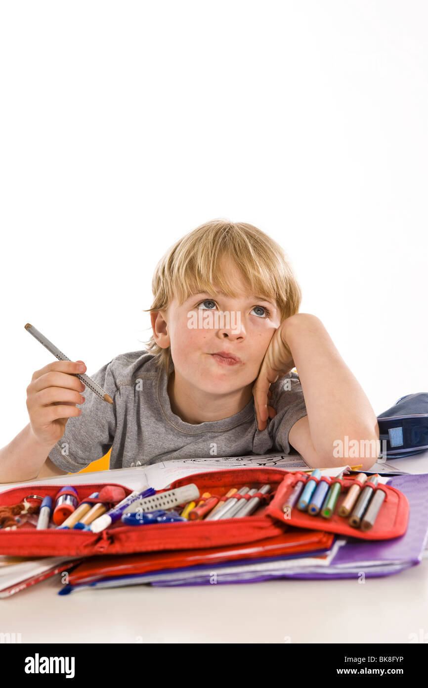 Pensive-looking boy doing his homework Stock Photo