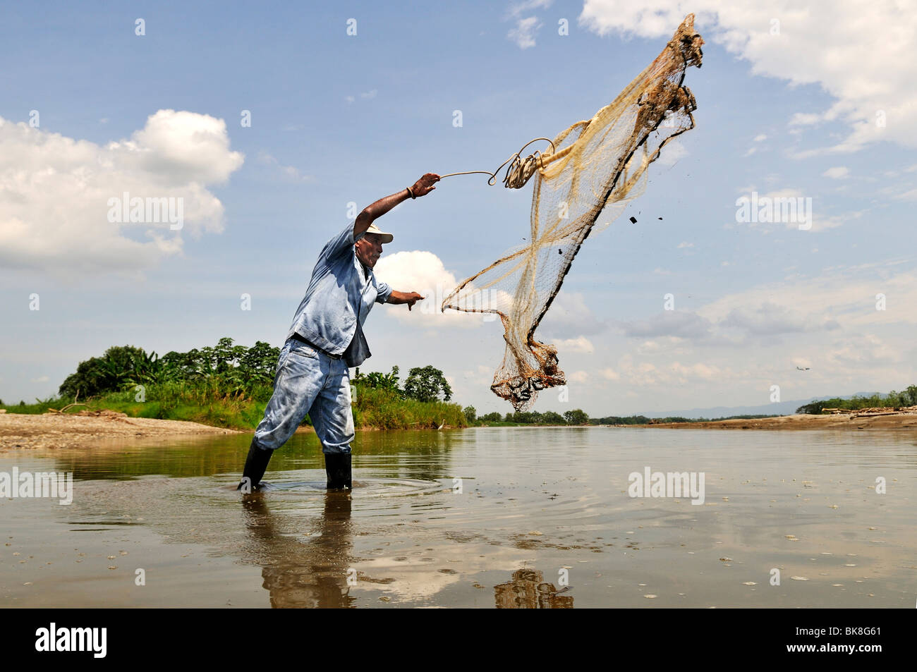 Fisherman tossing a net into the Rio Magdalena River, La Dorada, Caldas, Colombia, South America Stock Photo