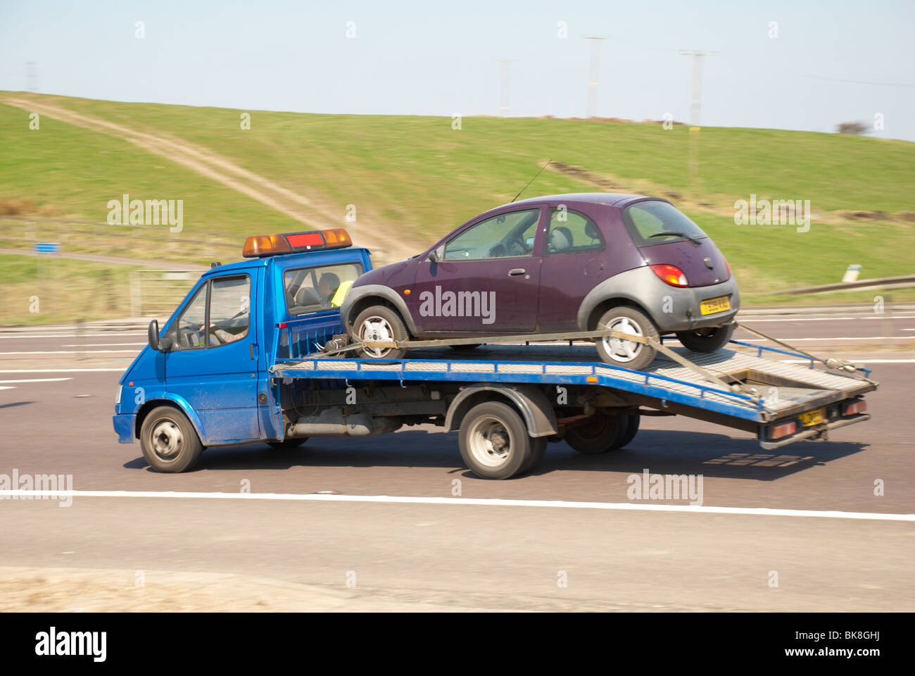 Broken down car on a flatbed truck Stock Photo