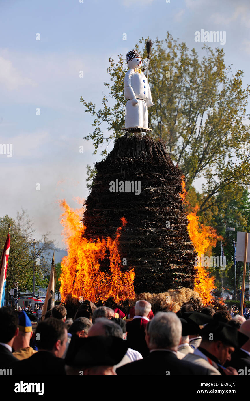 The Boeoeg, a doll symbolizing winter, is burned at the Sechselaeuten, traditional festival; the various guilds stand and ride Stock Photo