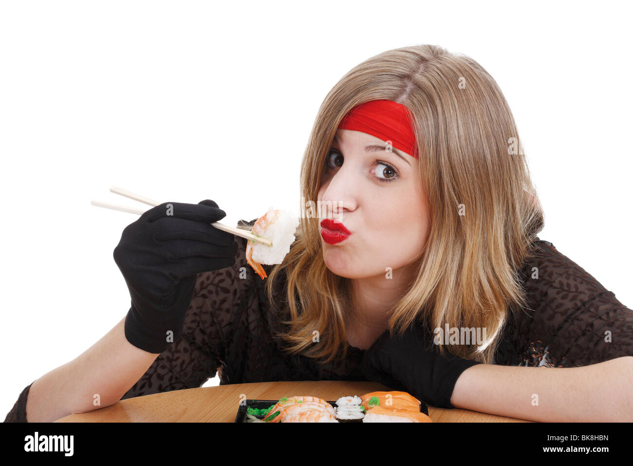 Young woman eating sushi with chopsticks Stock Photo