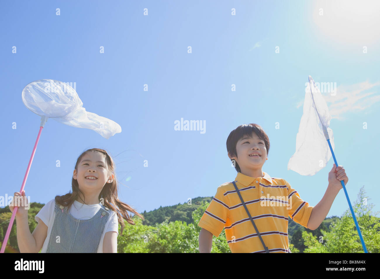 Boy and Girl Holding Butterfly Net Stock Photo