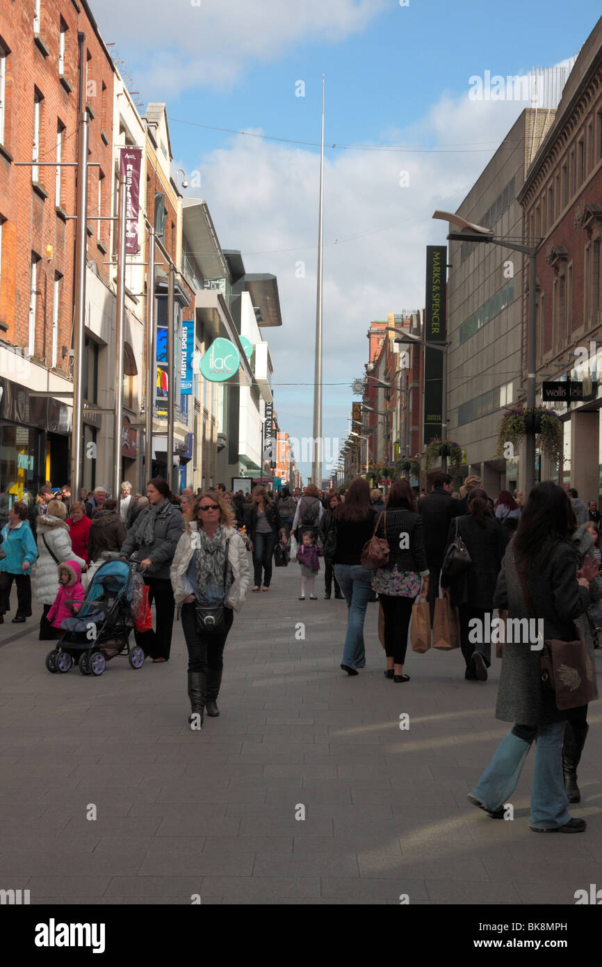 Crowds on Abbey Street with the Millenium Spire behind on O Connell Street in Dublin city centre Ireland Stock Photo