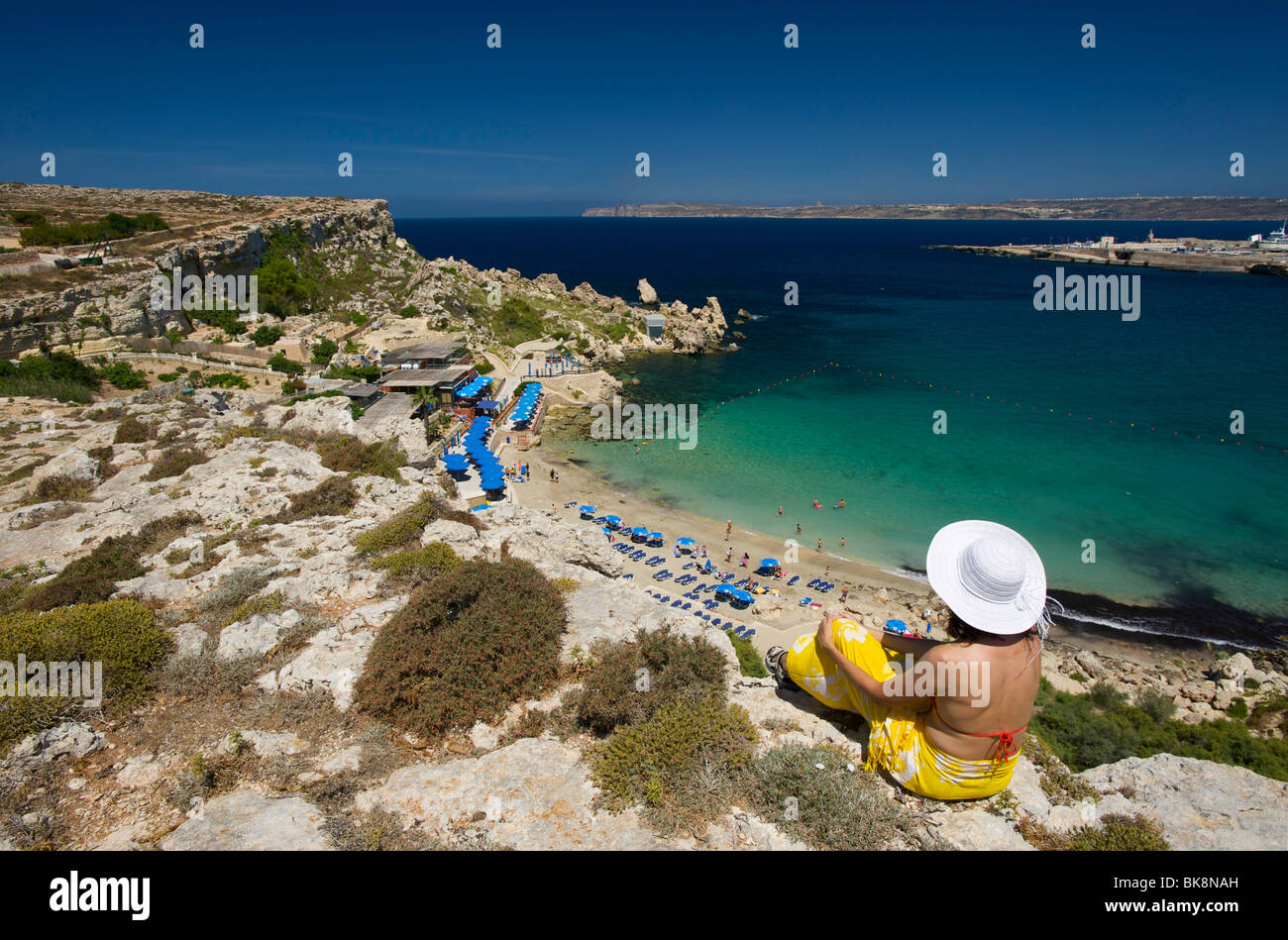 Woman looking on Paradise Bay in Cirkewwa, Malta, Europe Stock Photo