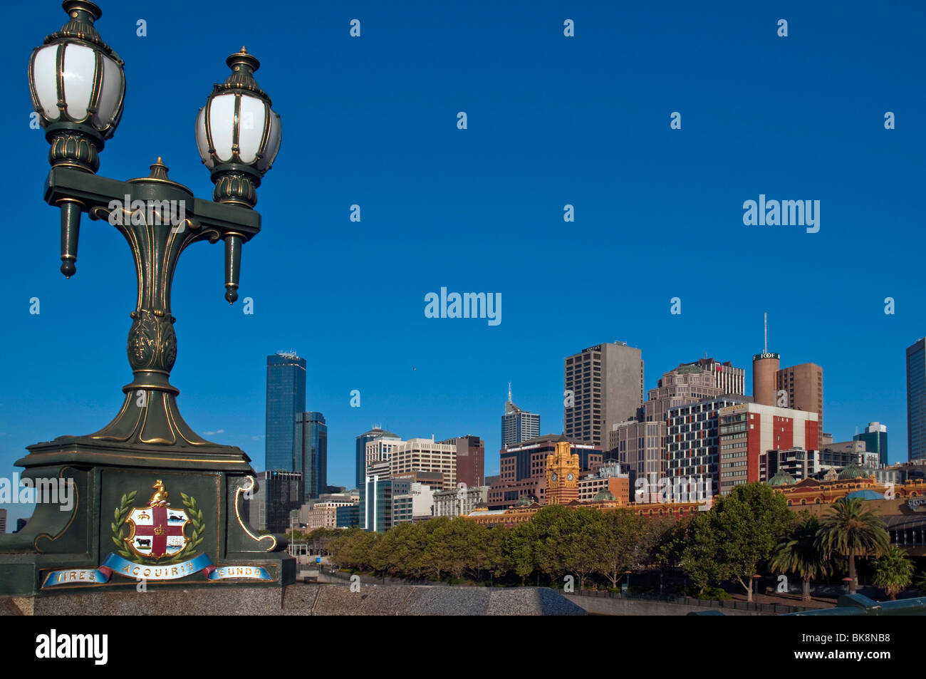 Melbourne skyline from Princes Bridge with city coat of arms on lamp standard Stock Photo
