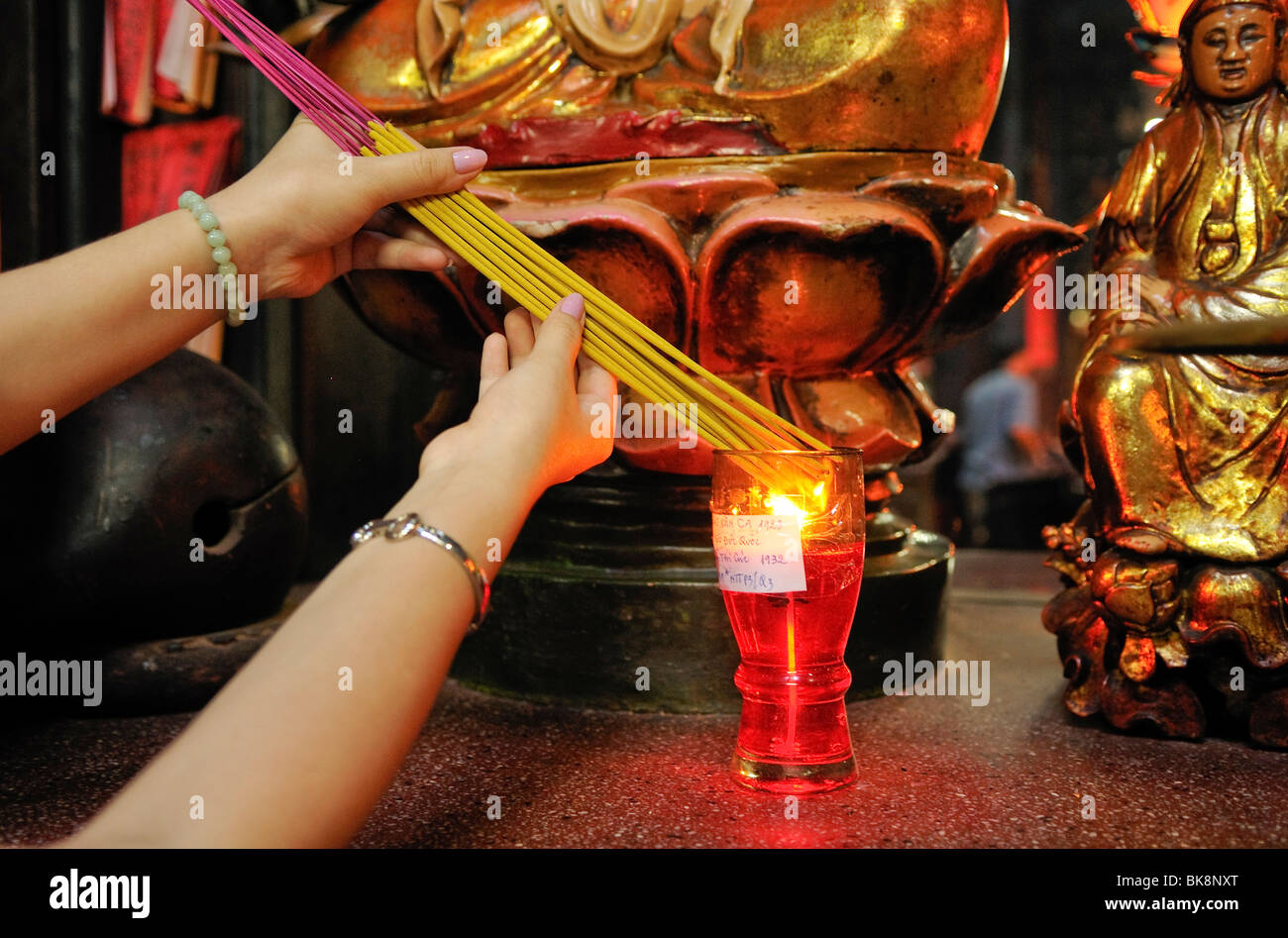 Igniting incense in Phuoc An Hoi Quan Pagoda, Ho Chi Minh City, Saigon, Vietnam, Southeast Asia Stock Photo