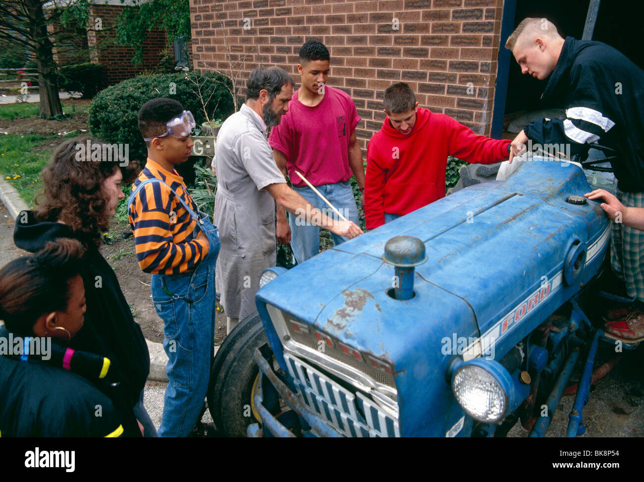 Professor teaching high school students tractor repair, Saul School of Agricultural Science, Philadelphia, Pennsylvania, USA Stock Photo