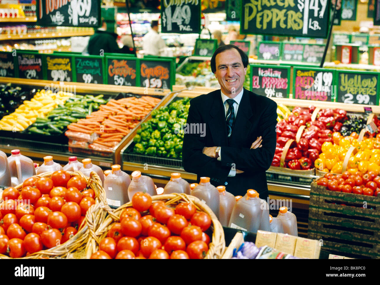 Environmental portrait of the President and CEO of a chain of grocery stores in the produce section of one of his stores Stock Photo