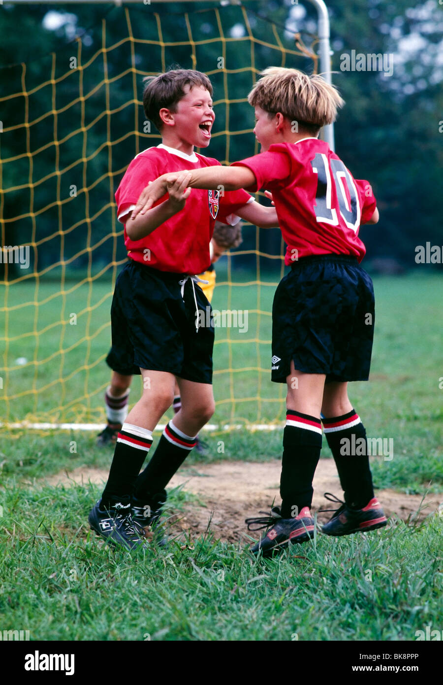 Young boys in uniform celebrating a soccer goal Stock Photo Alamy