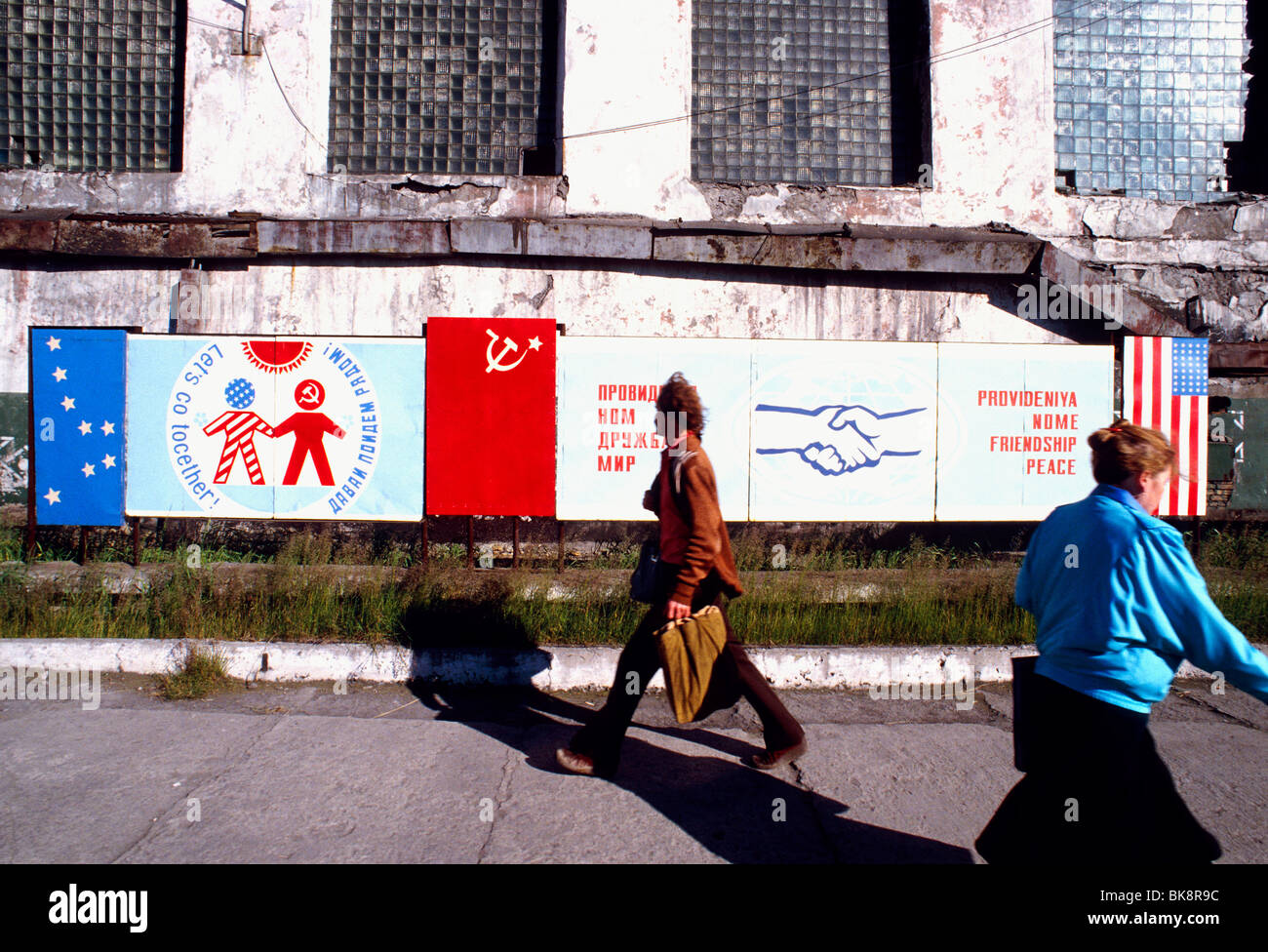 Pedestrians & signage in gateway city of Provideniya symbolizes the friendship between the former Soviet Union and Nome, Alaska Stock Photo
