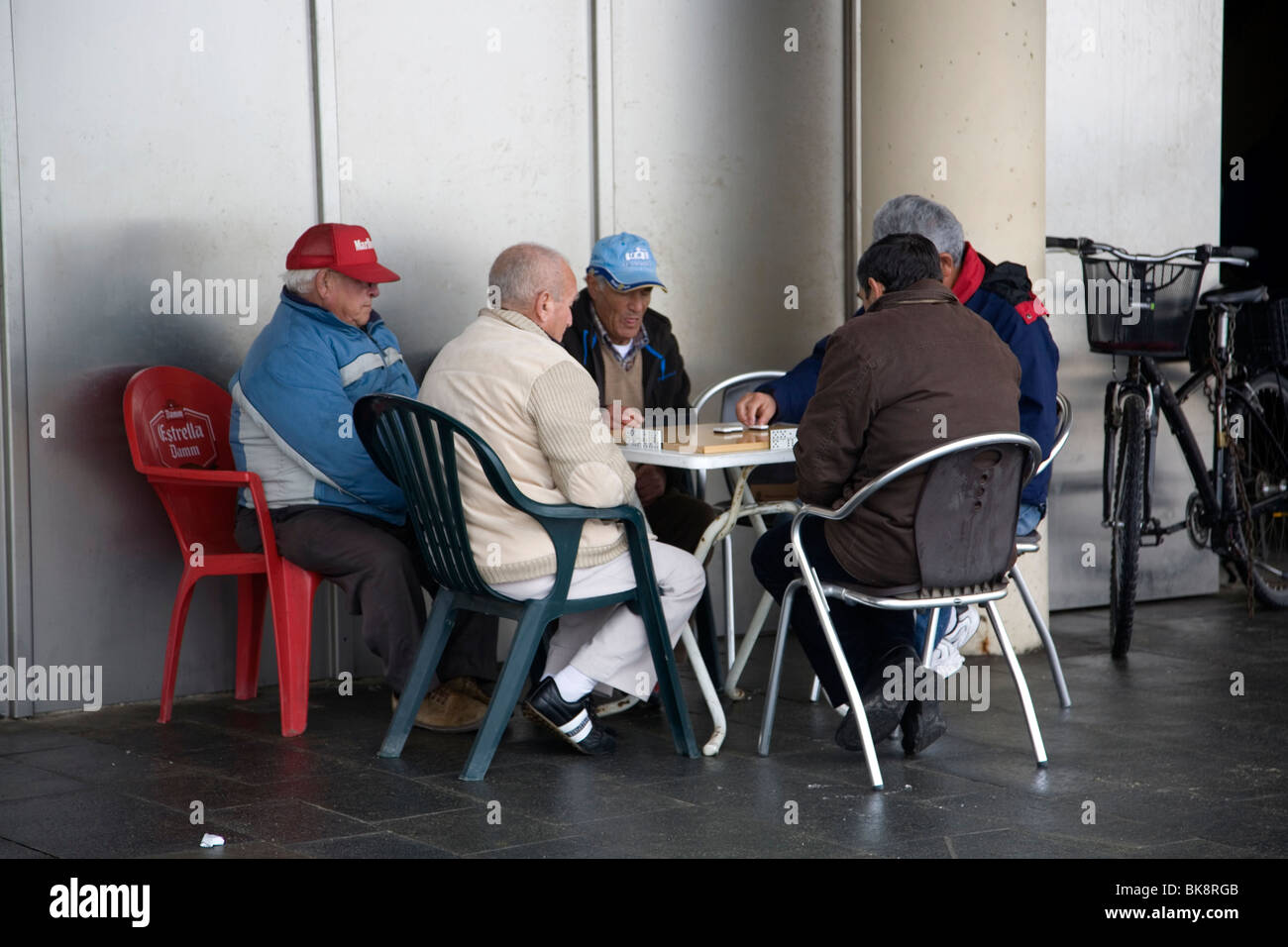 Old Men playing dominoes at Barceloneta Beach Stock Photo