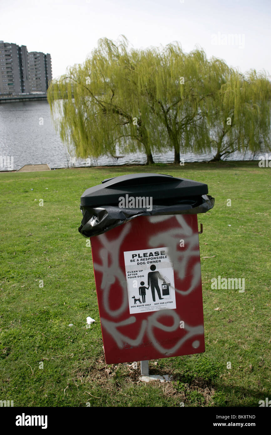 Litter bin and clean up after your dog sign in Southmere Park, Thamesmead, southeast London, UK Stock Photo