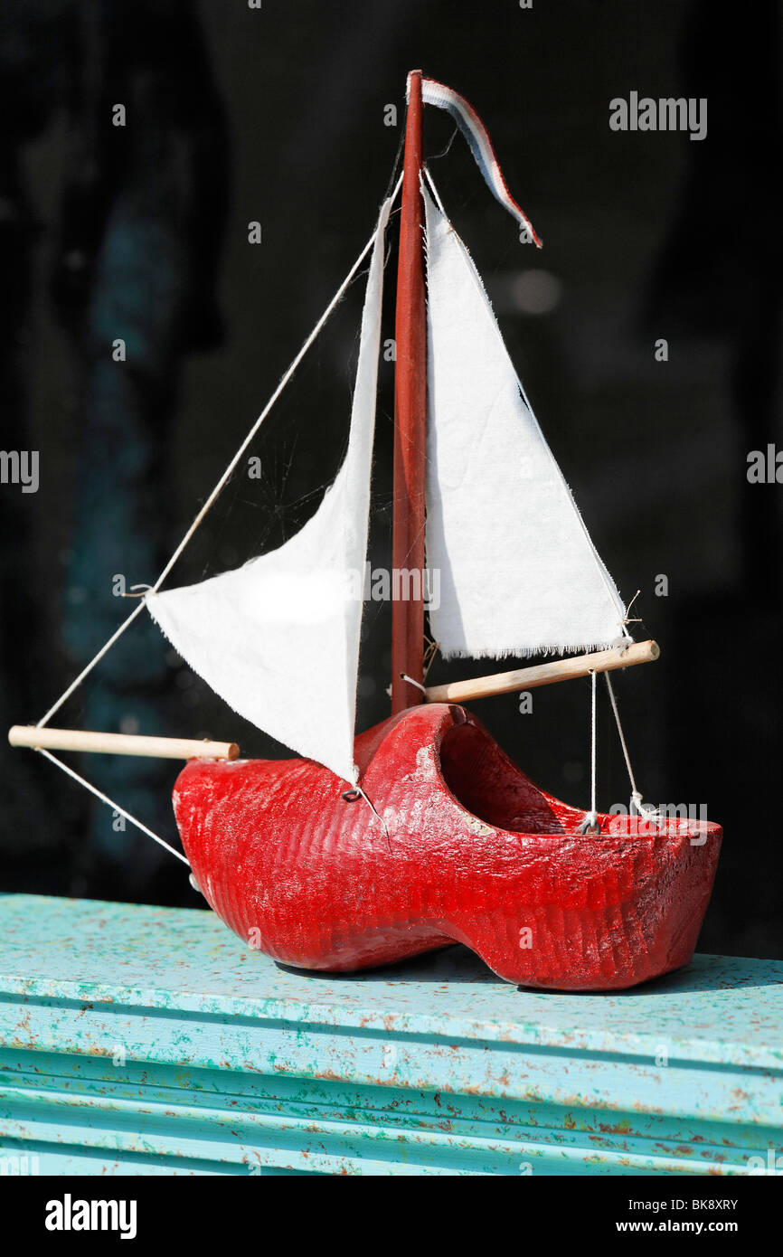Small sailboat in the display window, made of Dutch wooden clogs, lettering 'Klompen', Dutch for 'clogs', handicrafted, De Rijp Stock Photo