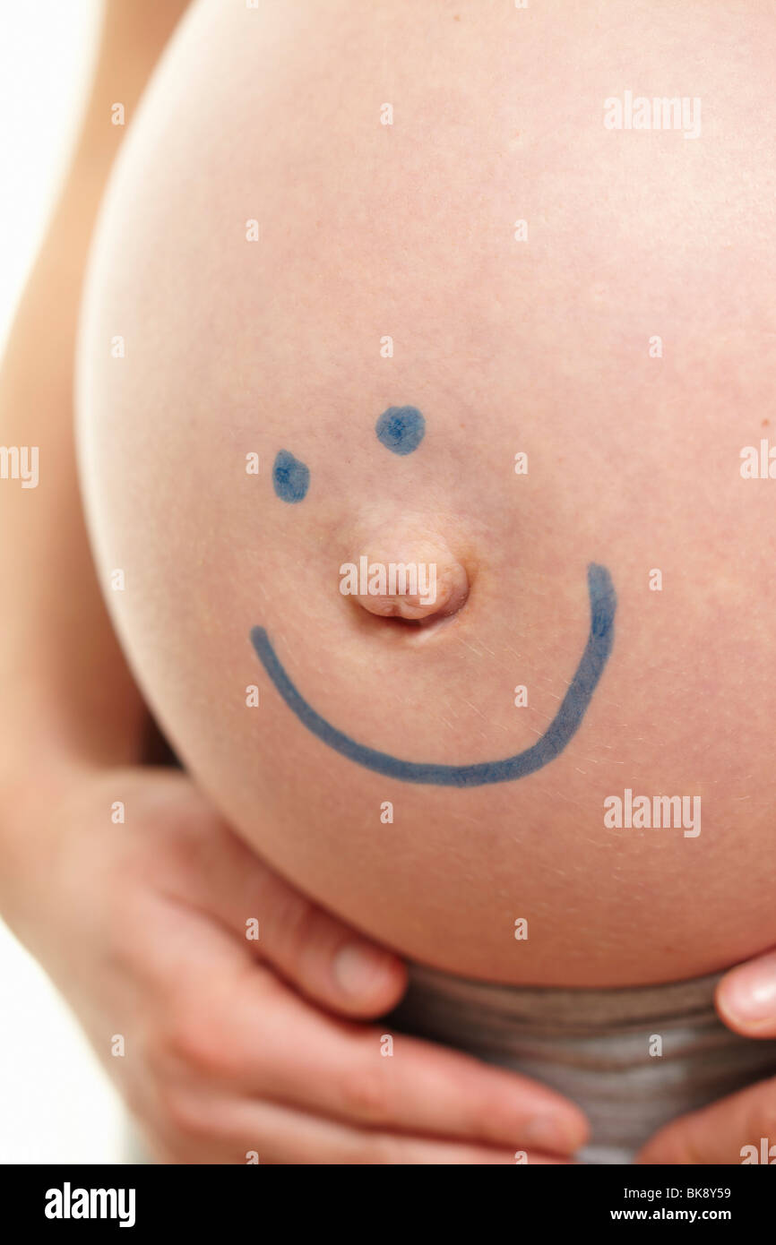 Pregnant belly with smiley face Stock Photo