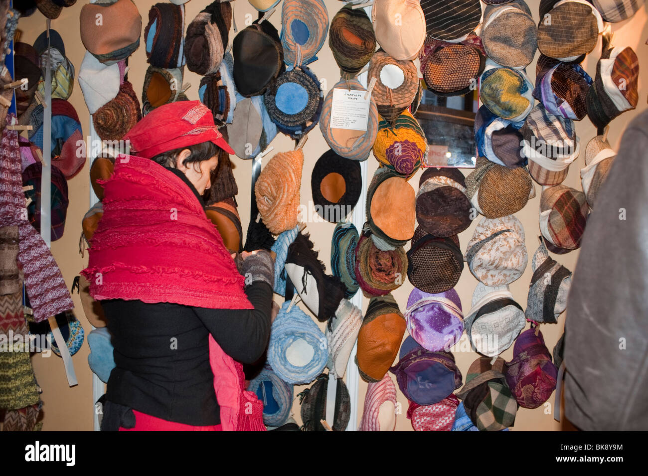 Woman buying hats hi-res stock 