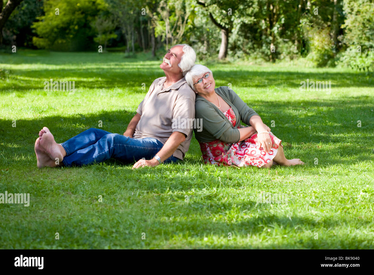 Grandparents relaxing in the garden Stock Photo
