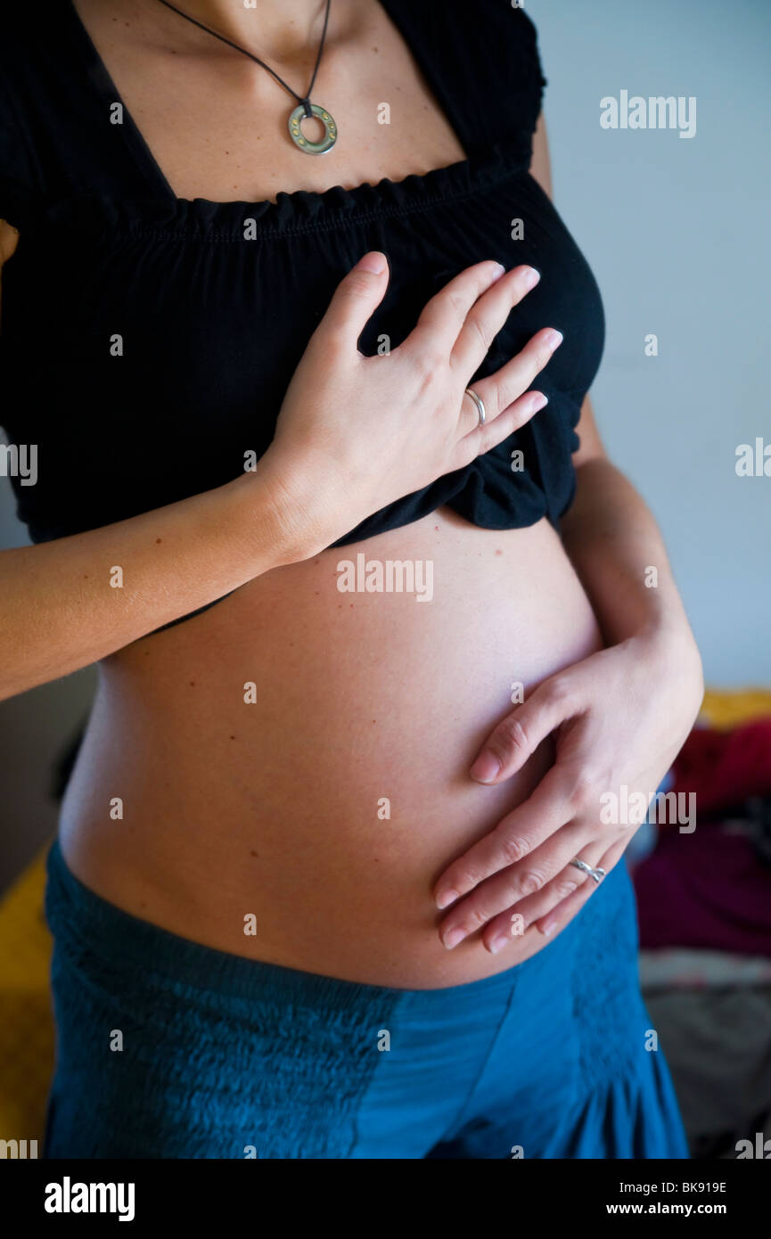 Pregnant woman showing belly High Resolution Stock Photography and