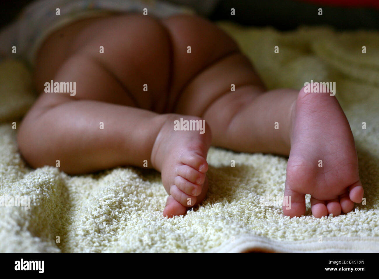 A baby girl is trying to crawl. Stock Photo