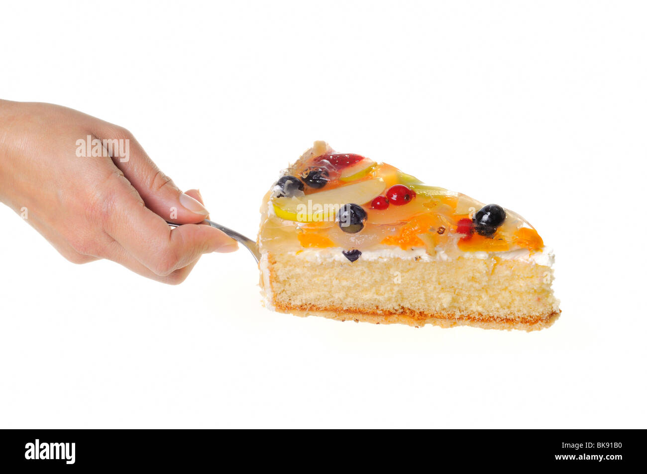 Woman's hand serving a piece of fruit cake on a cake server Stock Photo