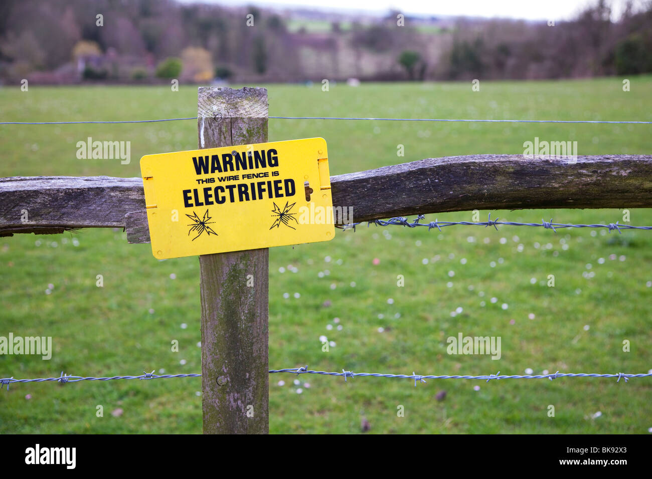 An electric fence around a field in the UK. Stock Photo