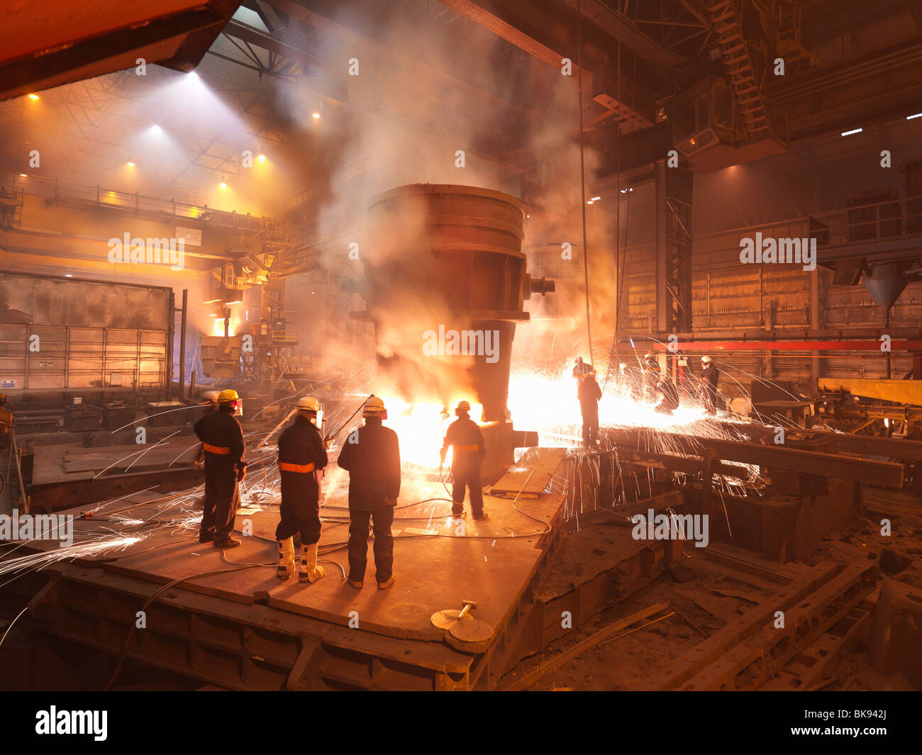 Workers With Molten Steel In Plant Stock Photo