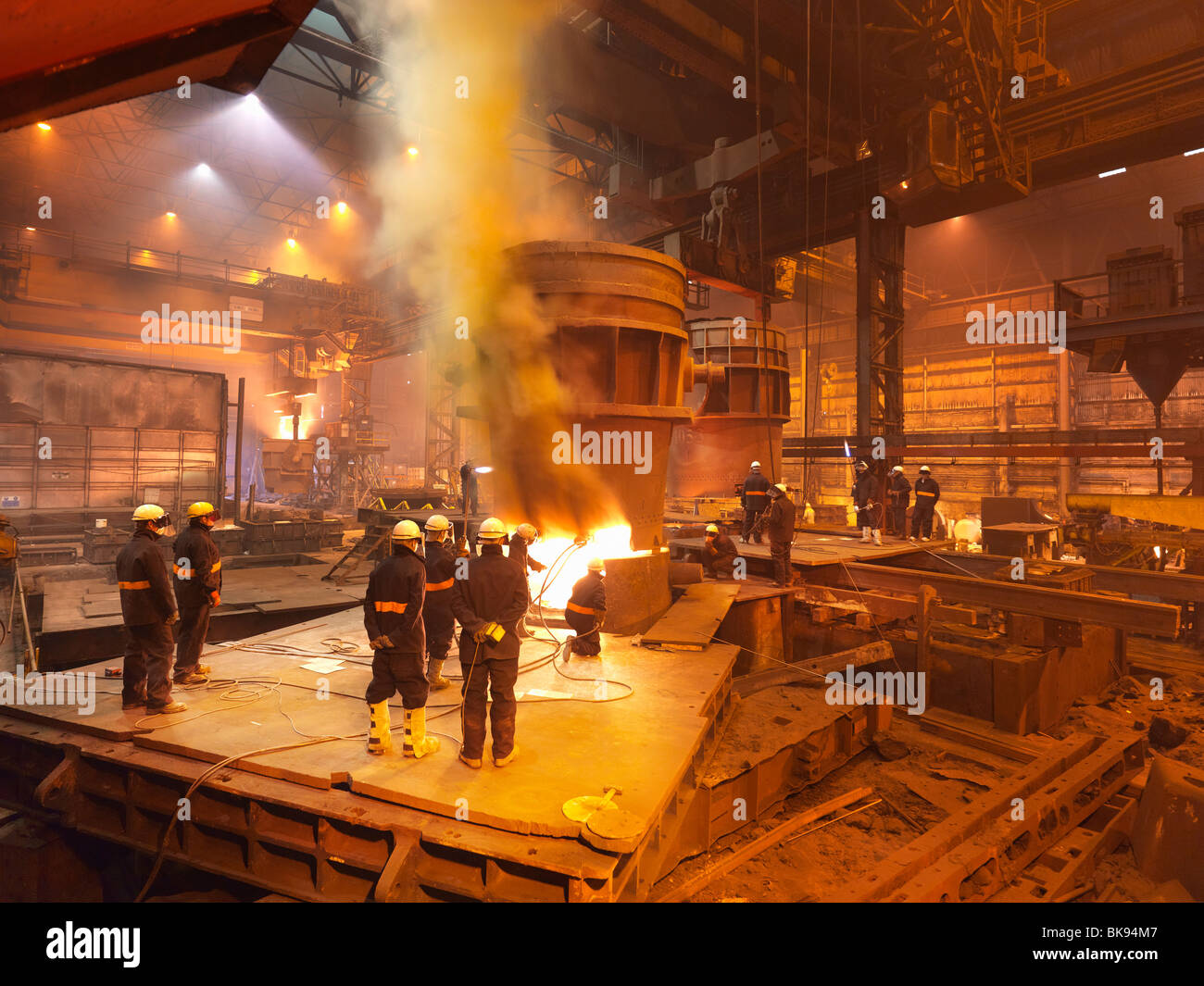 Steel Workers In Plant Working On Ladle Stock Photo