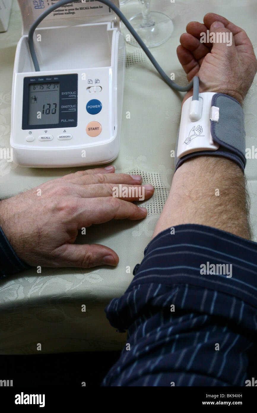 man self testing blood pressure and heart rate with a digital blood