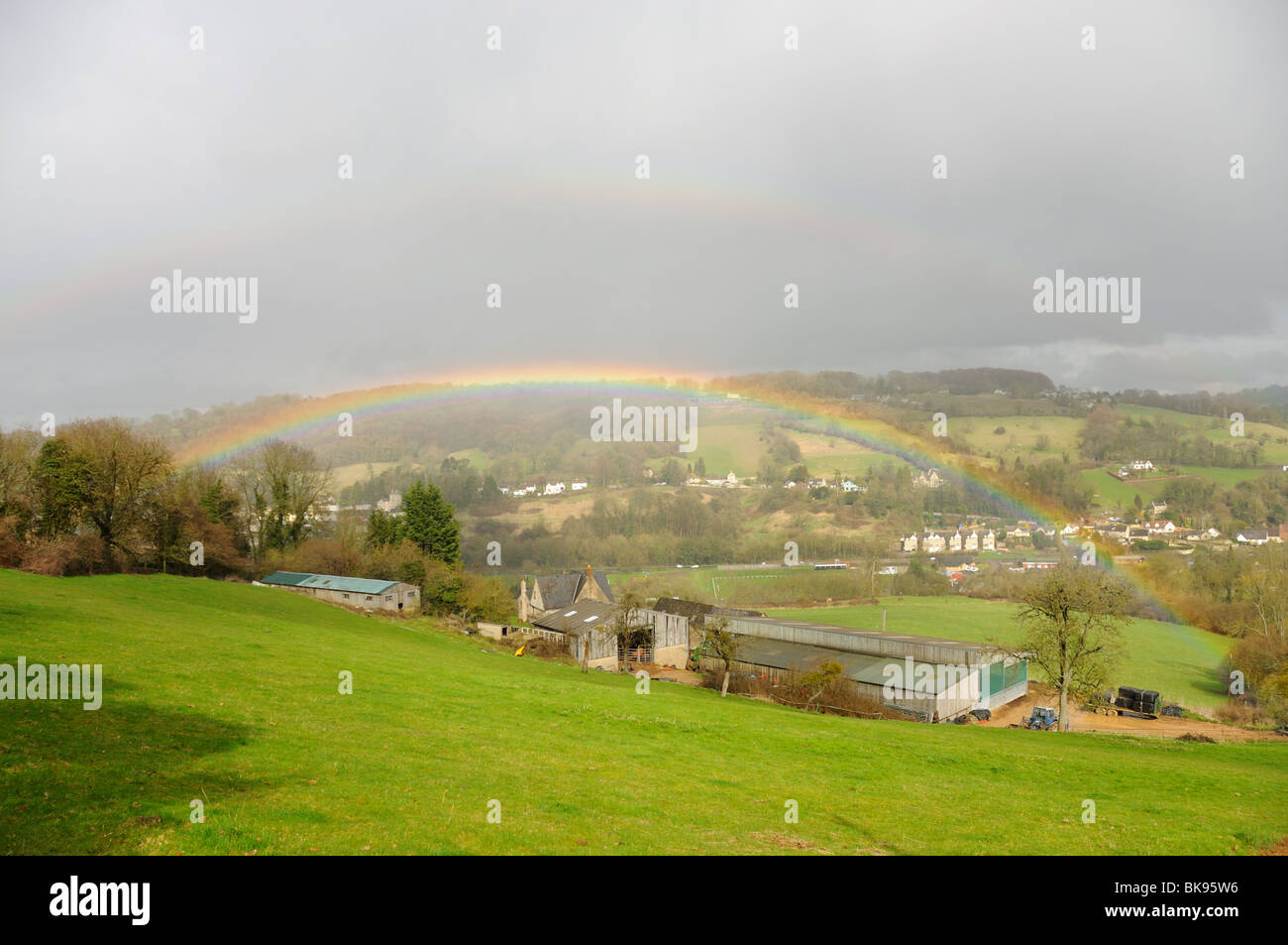 Rainbow over farmland near Stroud Gloucestershire Stock Photo