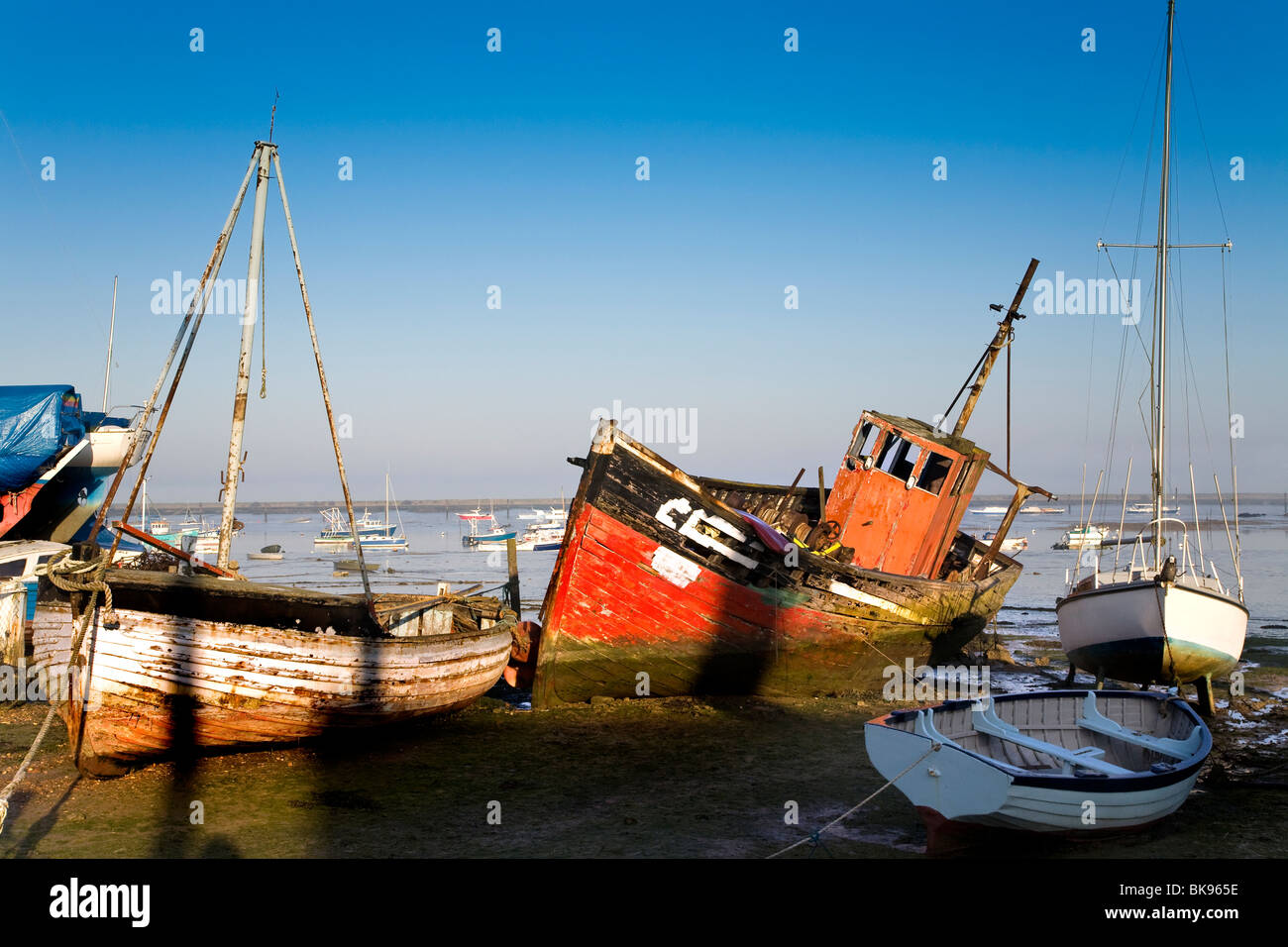 AN OLD ROTTING WOODEN BOAT AT LOW TIDE, WEST MERSEA Stock Photo - Alamy