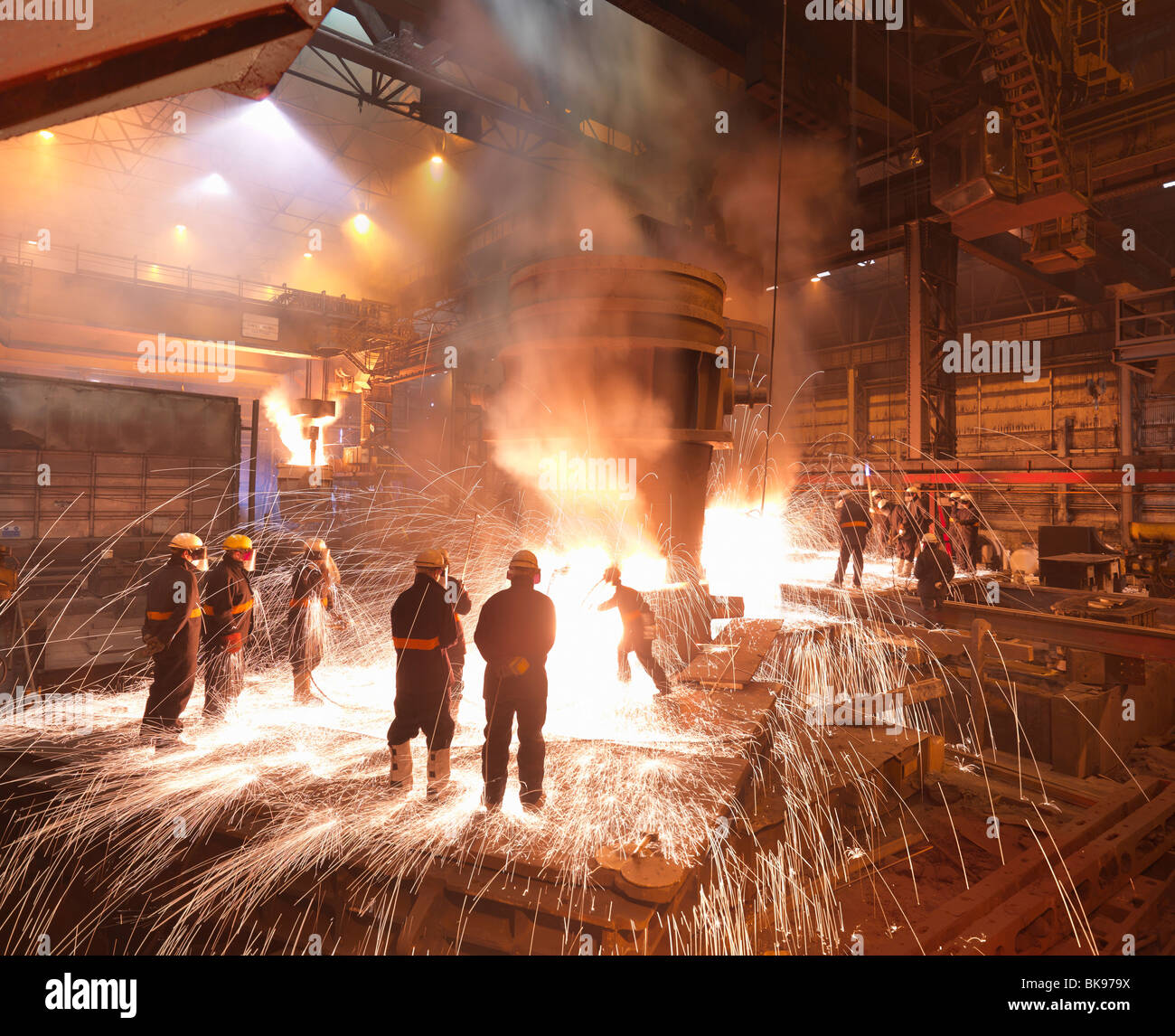Workers With Molten Steel In Plant Stock Photo