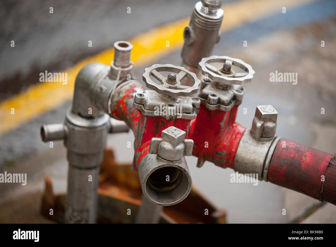 Fire Hydrant stand pipe with dividing branch and hose Stock Photo