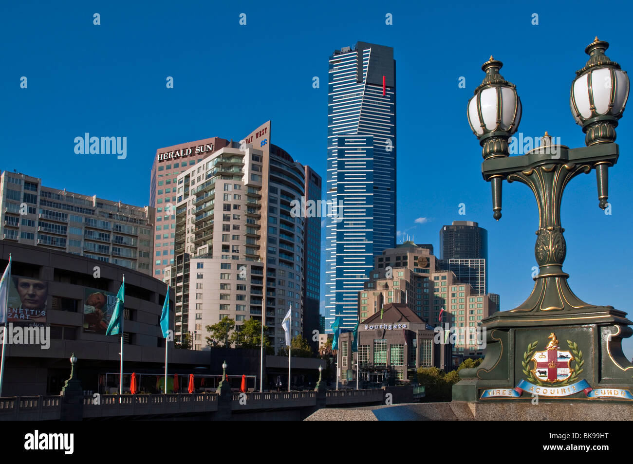 Melbourne skyline from Princes Bridge with city coat of arms on lamp standard Stock Photo