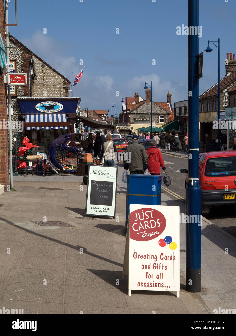 Station Road busy main street with traditional small shops in Sheringham North Norfolk Stock Photo