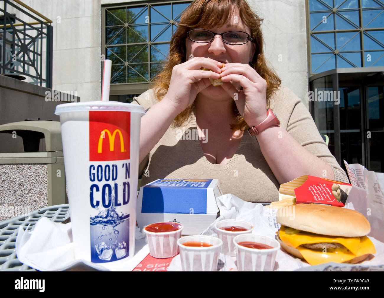 Overweight woman eating McDonald's fast food meal Stock Photo - Alamy