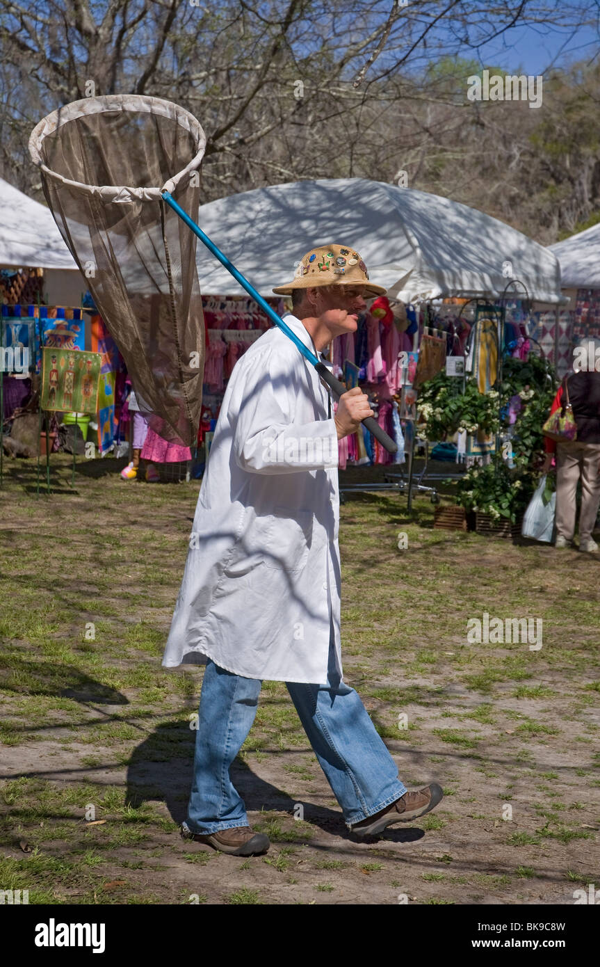 Kanapaha Spring Garden Festival Gainesville Florida man dressed as a butterfly  catcher with lab coat hat and large specimen net Stock Photo - Alamy