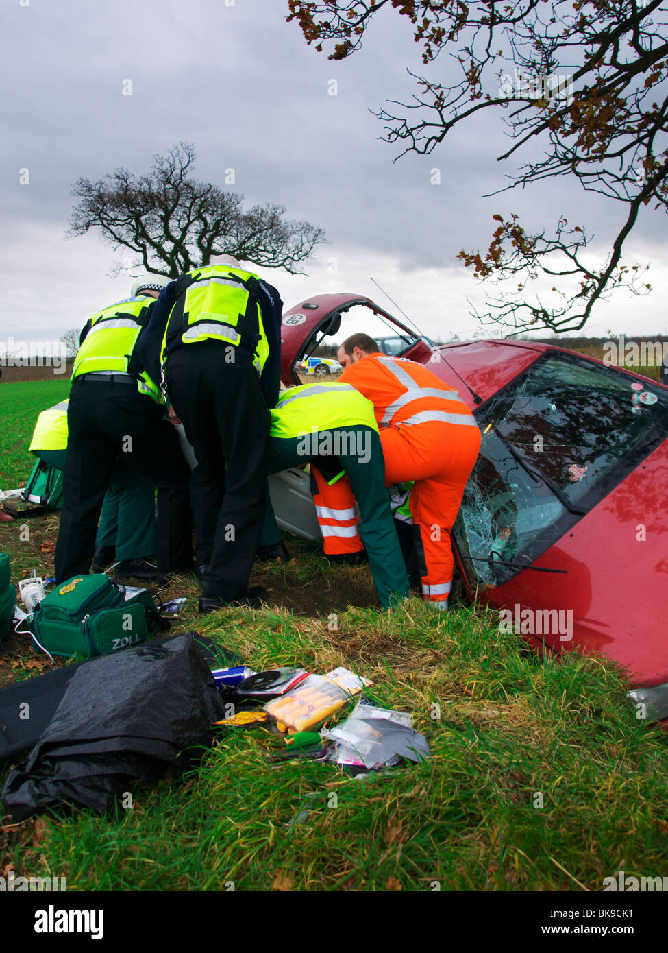 Police and Paramedics help to remove victim of a car crash from car in