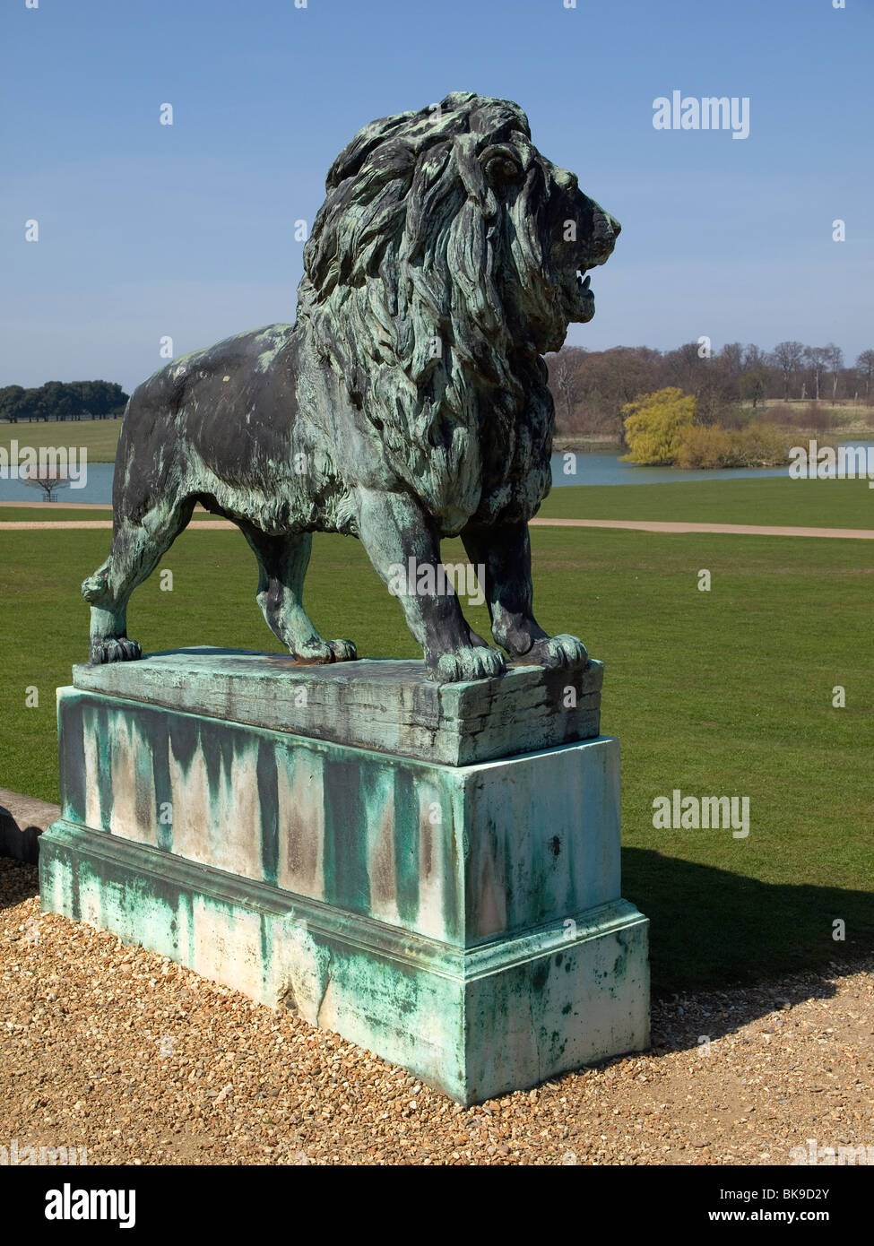 Bronze lion statue at the rear entrance to Holkham Hall Norfolk, home of Lord Coke Earl of Leicester Stock Photo